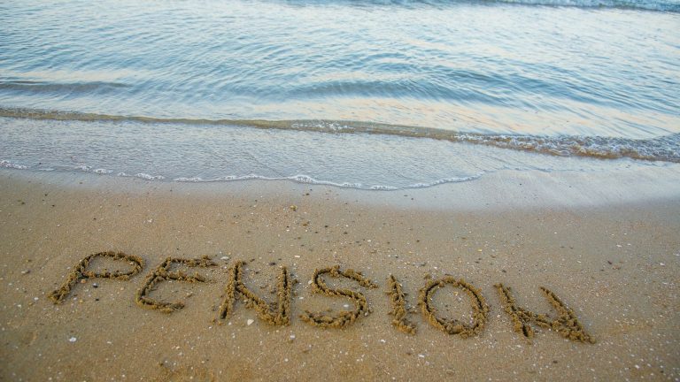 pension written in sand on beach bankrupt canada